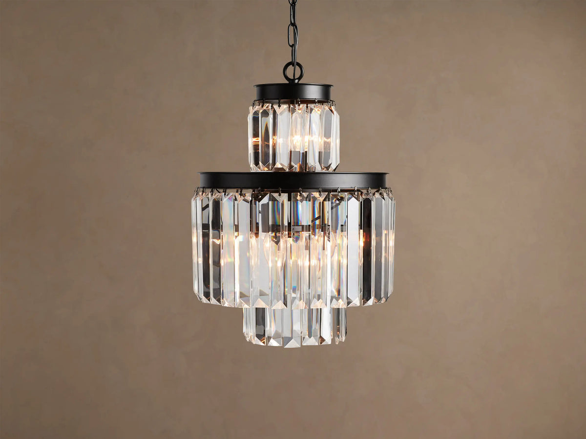 Leyland Chandelier: Multi-tiered fixture with an oil-rubbed black iron frame and clear faceted K9 glass crystals, illuminated.