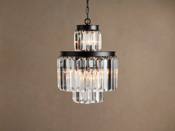 Leyland Chandelier: Multi-tiered fixture with an oil-rubbed black iron frame and clear faceted K9 glass crystals, illuminated.