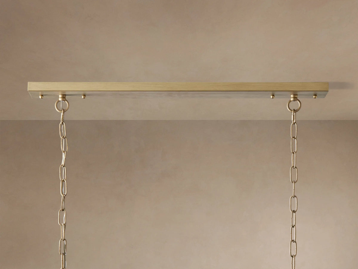 Leyland Tiered Rectangular Chandelier: Oil-rubbed bronze frame with two tiers of clear K9 glass crystals, illuminated, hanging by chains.