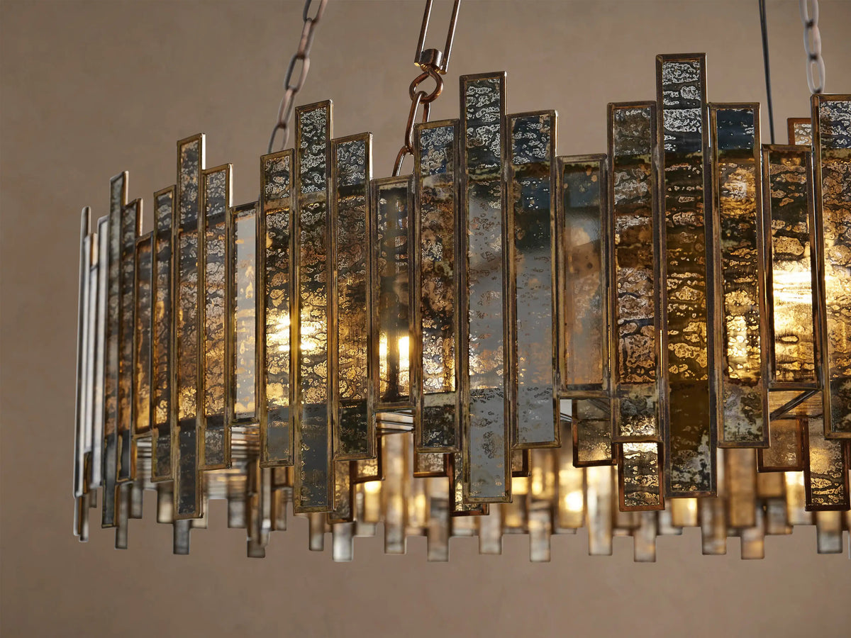 Laila round chandelier with antique copper frame forming a ring of varied height vertical antiqued mirrored-glass panes, suspended.
