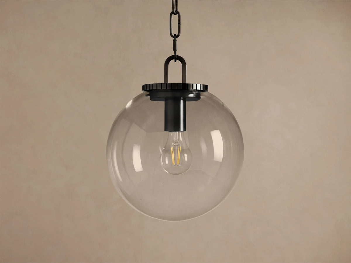 Wescott Globe Pendant: Clear glass globe with a visible filament bulb, dark metal chain and fixture, hanging against a neutral wall.