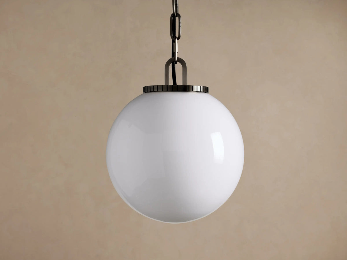 Wescott Globe Pendant: Opaque white glass globe with dark metal chain & fixture, hanging against a plain brown wall.