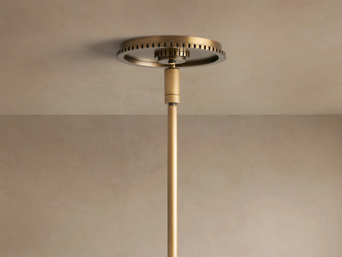 Close-up of Wescott Globe Pendant with Rod; white milk glass globe, ribbed brass finish ring, and a brass rod.