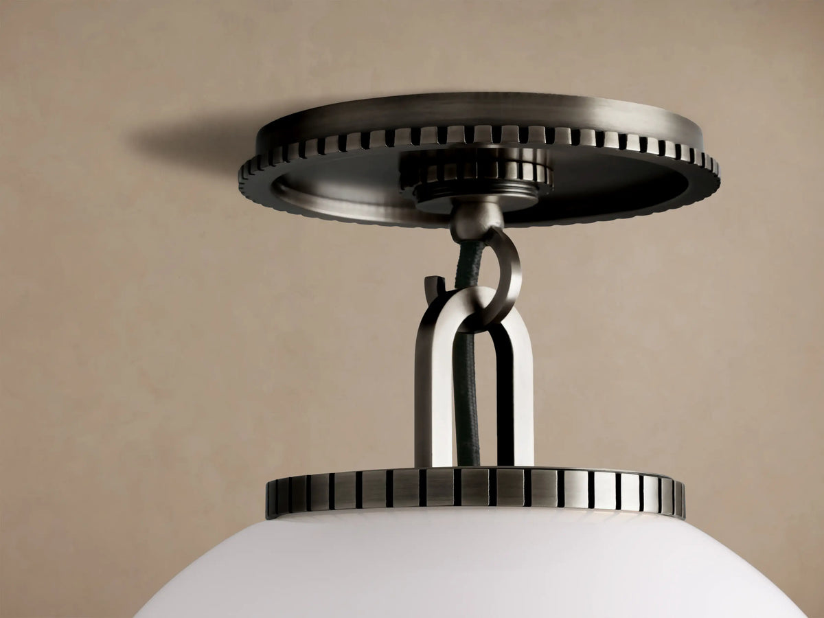 Wescott Globe Flush Mount with a white milk glass globe and dark bronze-toned metal hardware, flush-mounted on a beige ceiling.