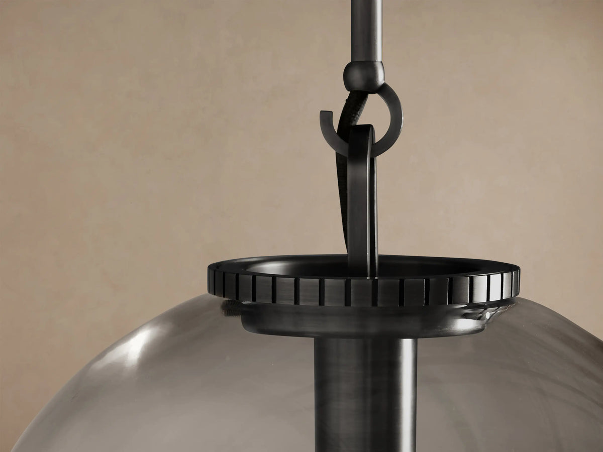 Wescott Globe Pendant with clear glass, dark bronze rod, and visible filament bulb, hanging.