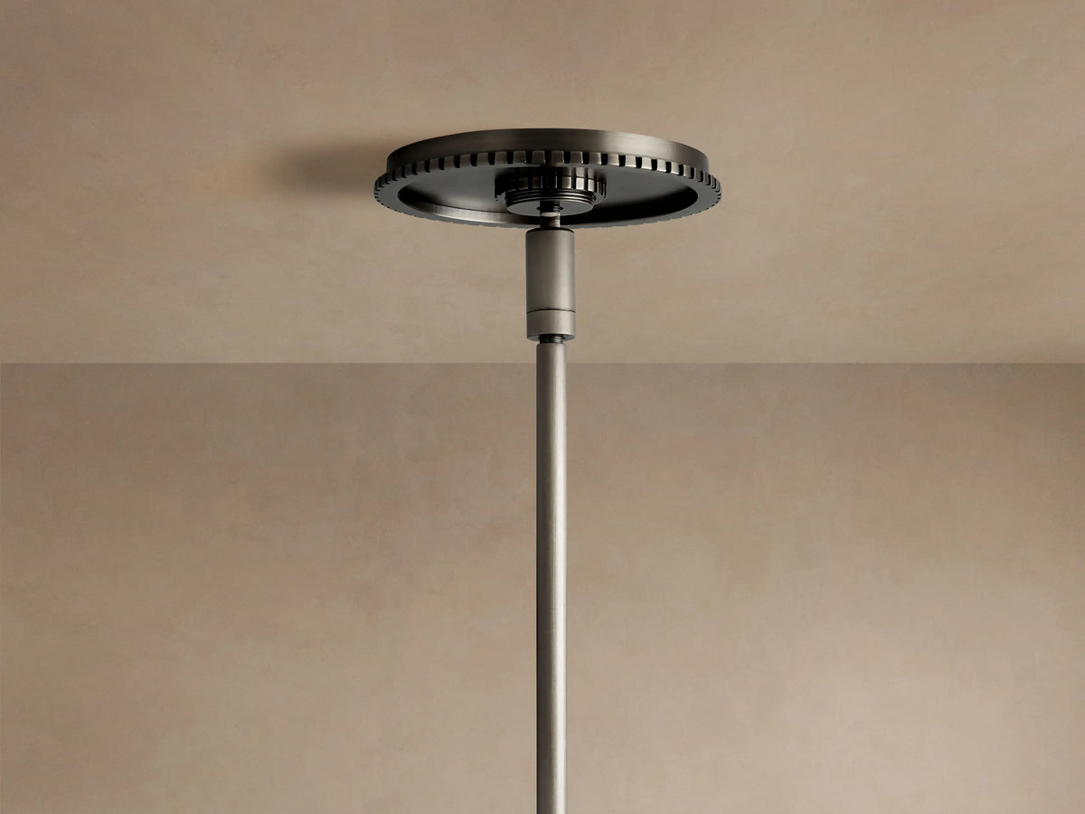 Wescott Globe Pendant: Close-up of dark bronze steel rod attached to a fluted ring holding a smoky clear glass globe.