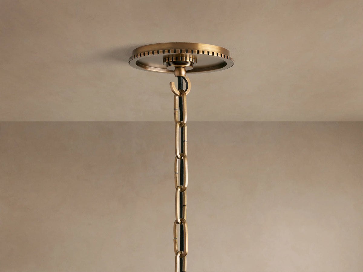 Close-up of Wescott Globe Pendant with a smooth white globe, brass-finished ring with grooved details, and brass rod.
