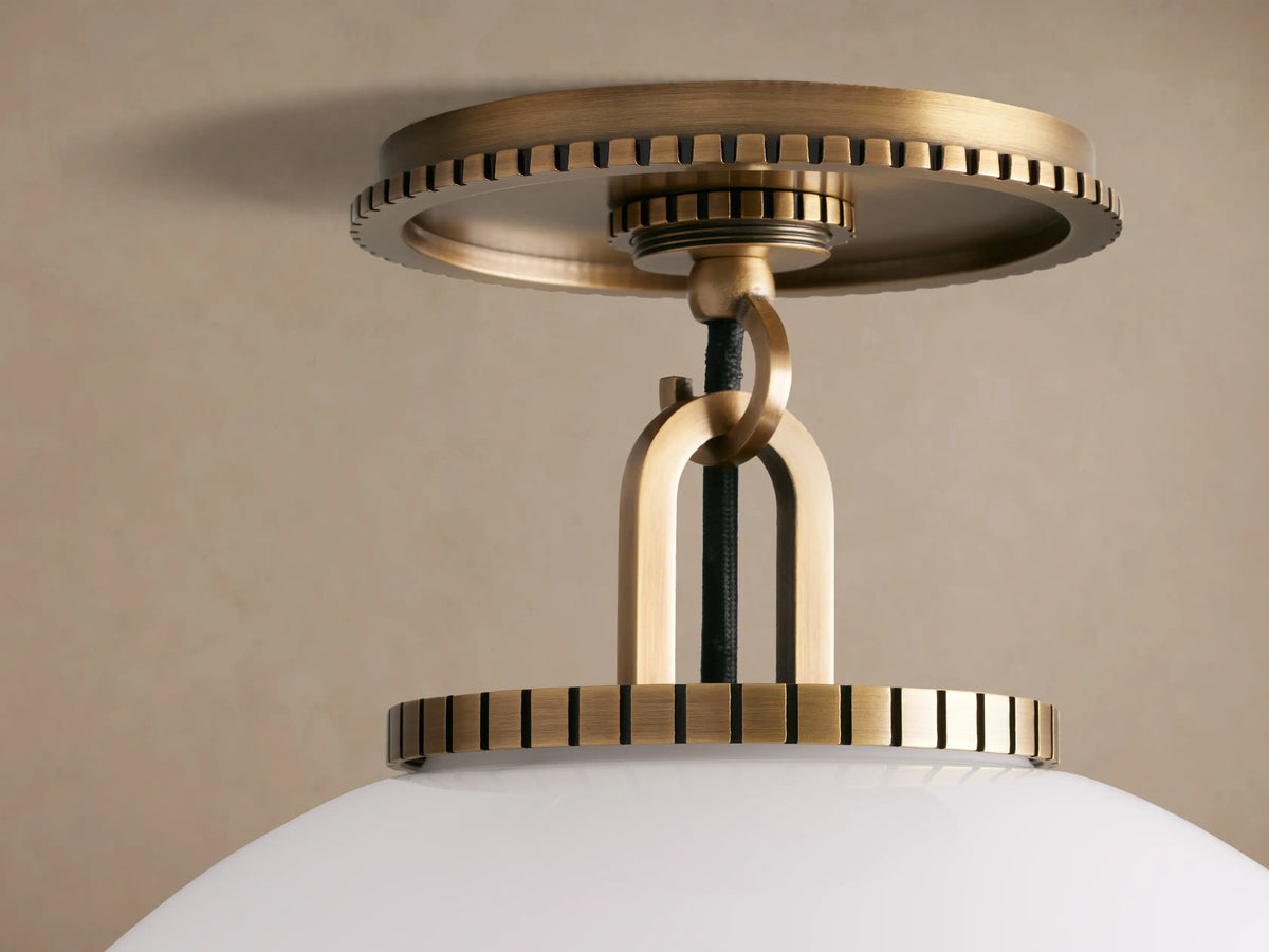 Wescott Globe Flush Mount: Spherical white milk glass globe, brass hardware, flush mounted to a light brown ceiling.