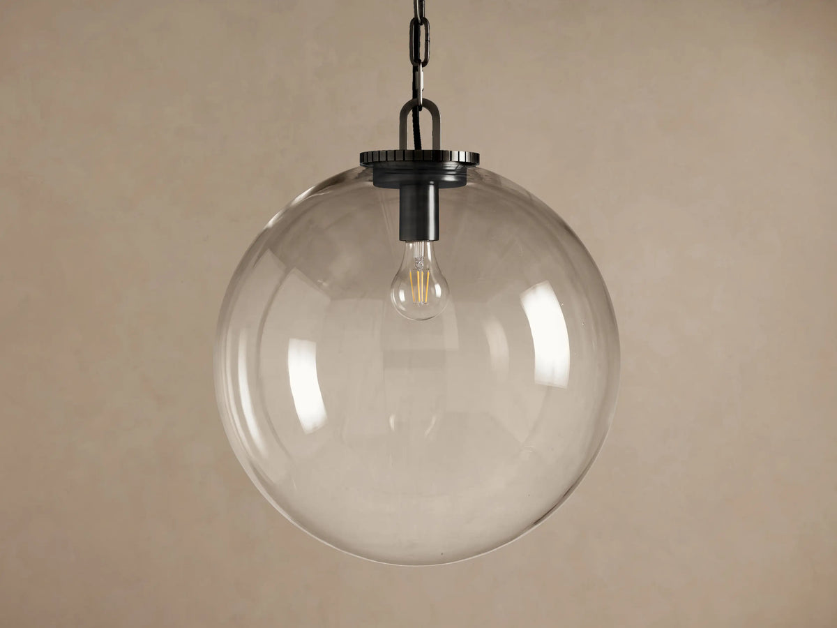 Wescott Globe Pendant: Clear glass globe with a visible filament bulb, suspended by a dark metal chain and fitting.