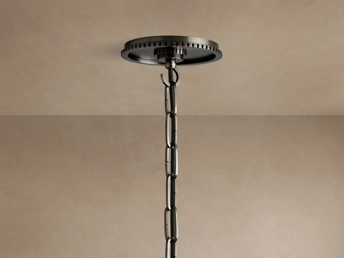 Close-up of Wescott Globe Pendant, showing top of clear glass globe, dark metal hardware with ribbed ring.