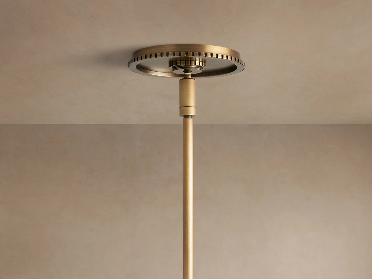 Close-up of Wescott Globe Pendant, smoky glass globe, brushed brass rod, decorative ring, and black cord from below.