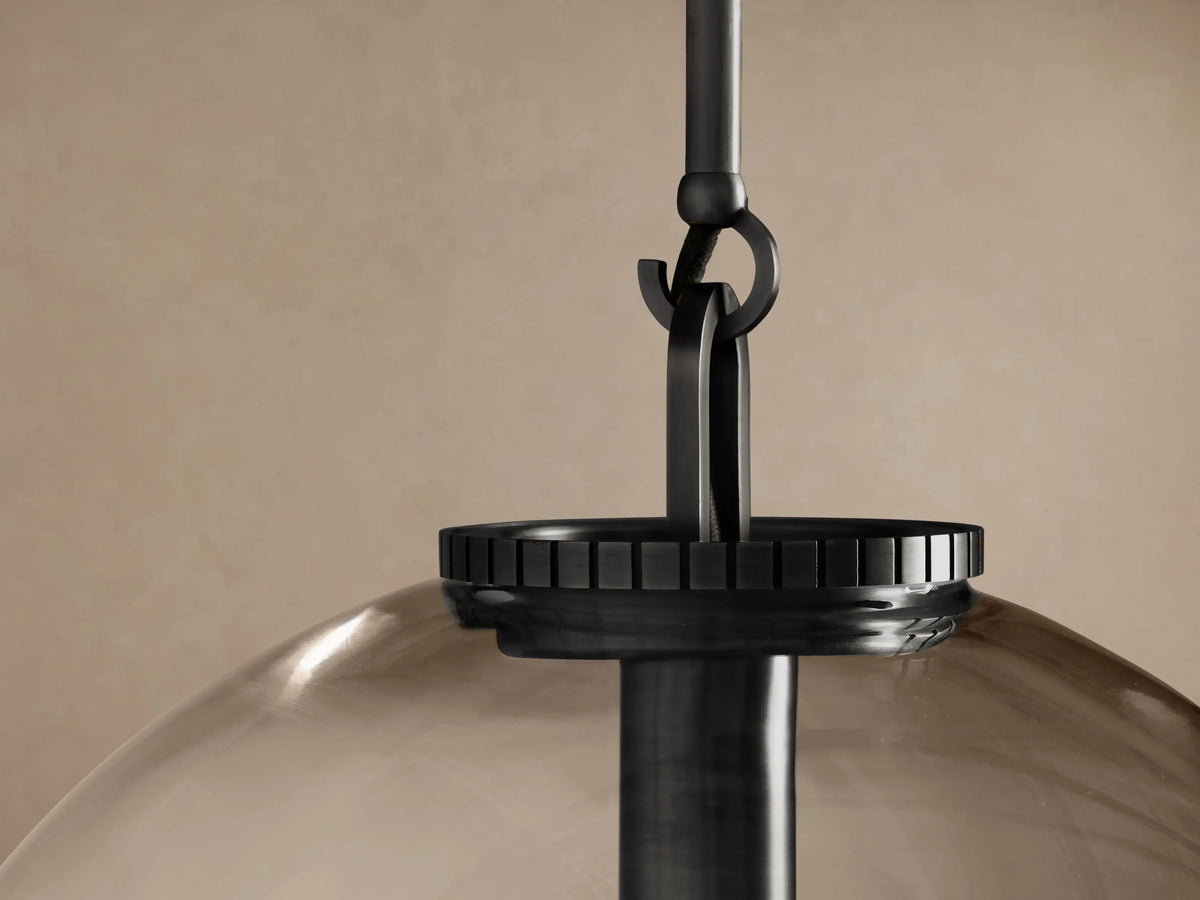 Wescott Globe Pendant with Rod, featuring a clear glass globe, dark metal rod, and an exposed filament bulb.