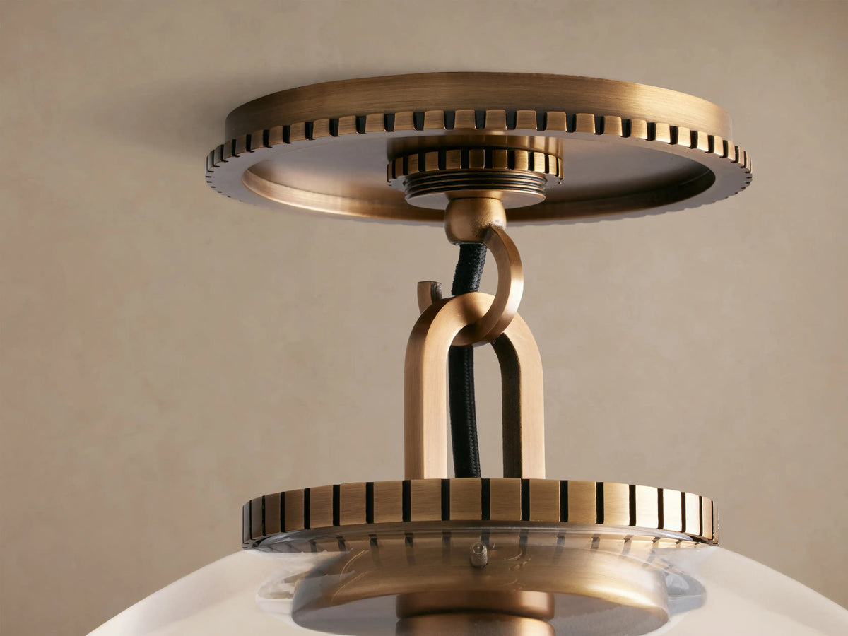 Wescott Globe Flush Mount with a clear glass globe, brass hardware, and a visible Edison bulb, mounted on a ceiling.