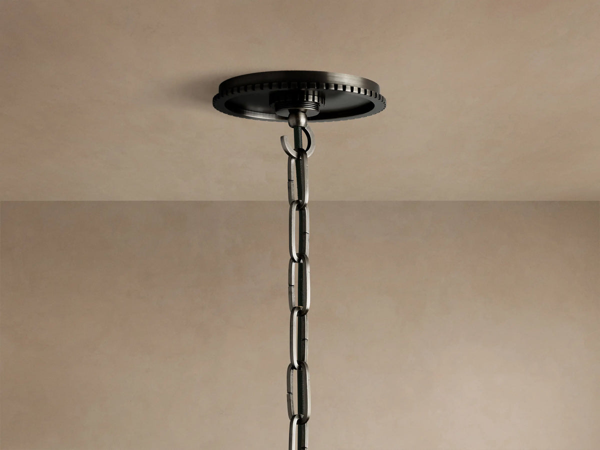 Wescott Globe Pendant: Close-up of a white milk glass globe meeting a dark bronze ribbed metal fitting and suspension rod.