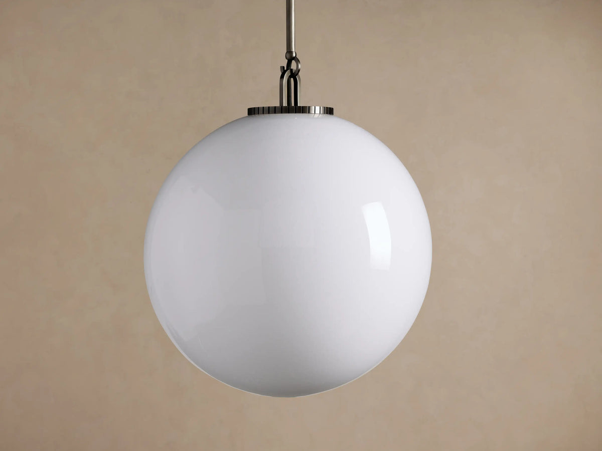 Wescott Globe Pendant: large, white milk glass globe hangs from a brushed silver-toned metal rod against a beige wall.