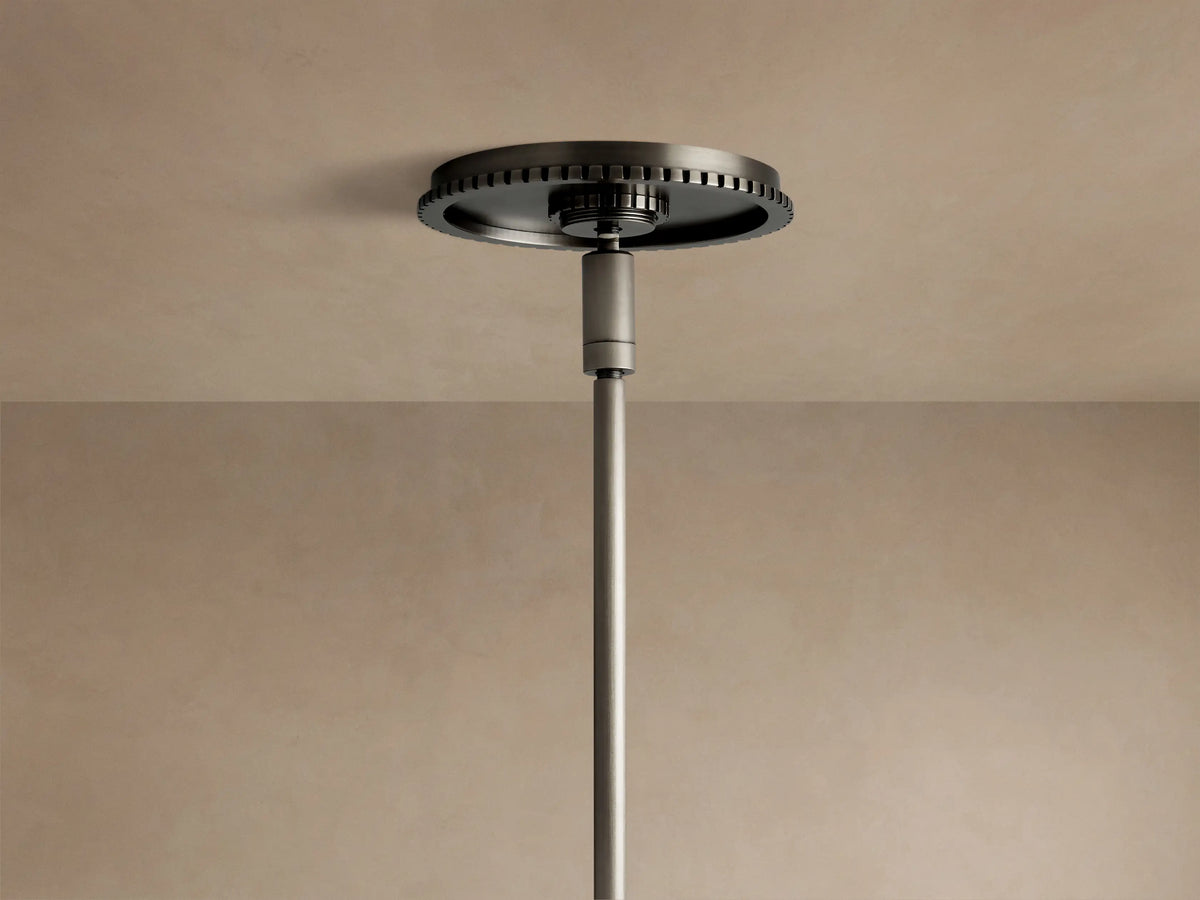 Close-up of Wescott Globe Pendant. White milk glass globe connects to a dark bronze ribbed metal ring and rod.