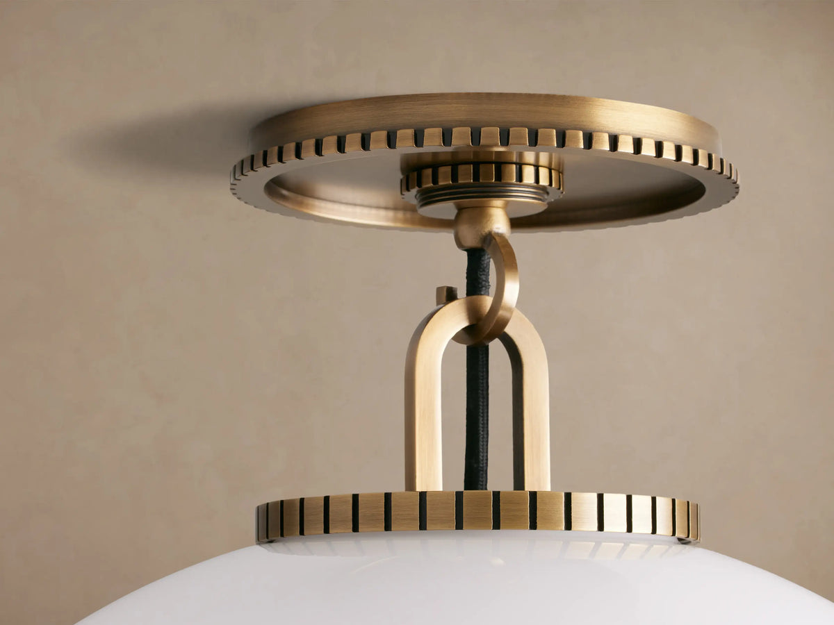 Wescott Globe Flush Mount with a large, round, white milk glass globe and brass hardware, mounted on a light beige ceiling.