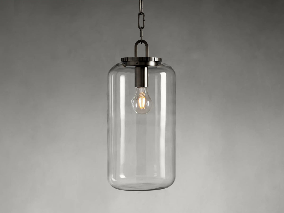 Wescott Cylinder Pendant with clear glass and bronze finish. Features an exposed bulb inside, hanging from a black chain.