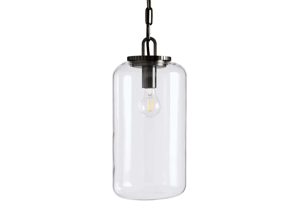The Wescott Cylinder Pendant features a clear glass shade with metallic accents, showcasing a visible bulb, suspended by a chain.