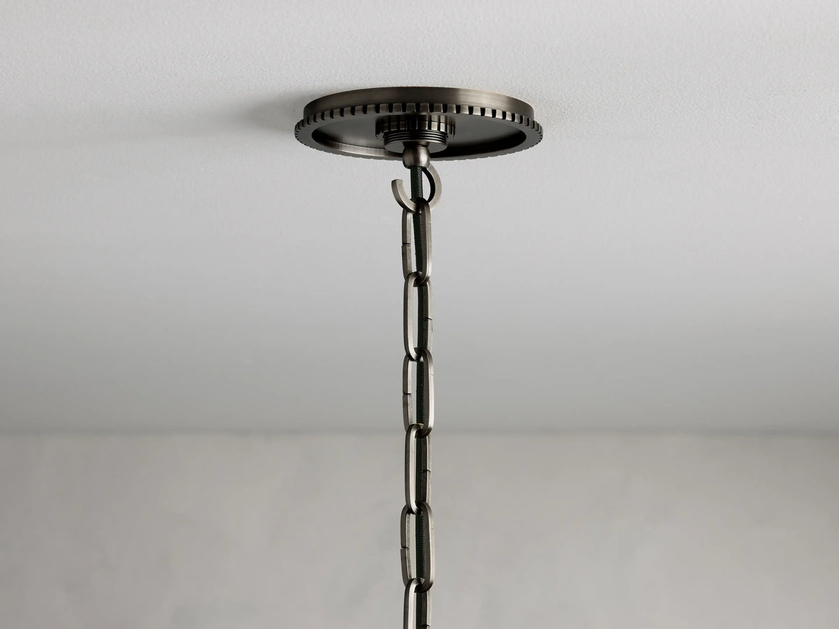 Wescott Cone Pendant with Chain features a bronze-finished round ceiling mount with a linked chain extending downward.