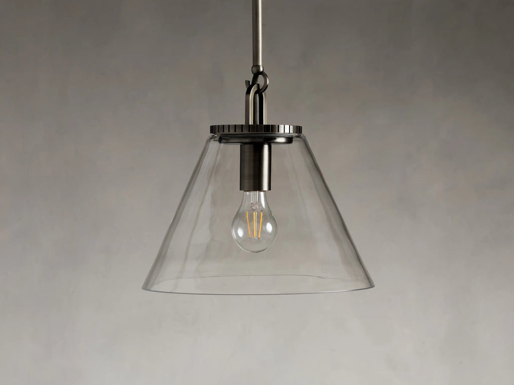 Close-up of the Wescott Cone Pendant in steel with a bronze finish, featuring a clear glass cone and a grooved metal top.