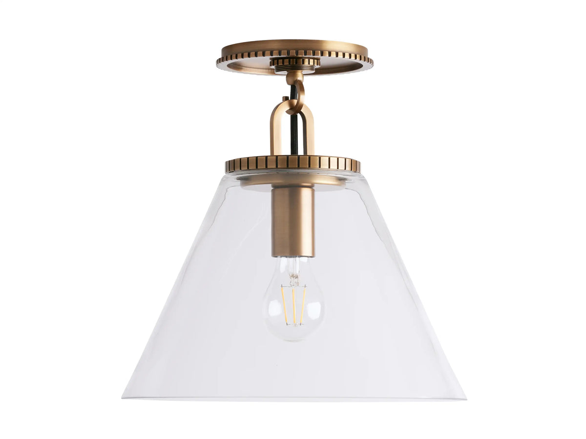 Cone-shaped flush mount with brass finish, clear glass shade, and visible bulb, mounted on a white ceiling.