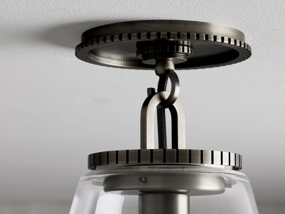 Wescott Cone Flush Mount in a bronze finish with clear glass cone shade, features a textured ceiling mount and black fabric-wrapped cord.
