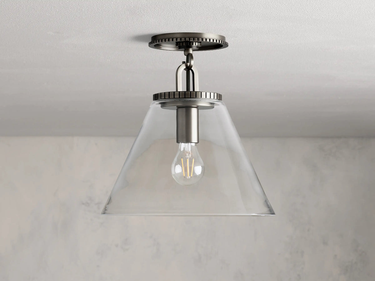Wescott Cone Flush Mount with clear glass cone shade, visible bulb, and brass finish, mounted on a white ceiling.