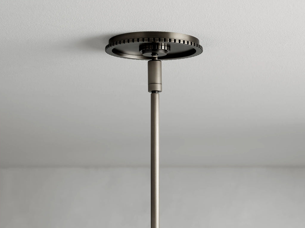 Wescott Cone Pendant featuring a clear glass cone shade with a bronze finish steel rim and rod, shown in close-up view.
