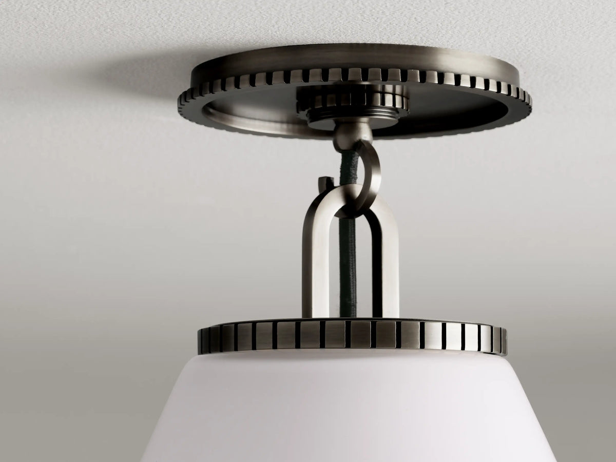 Cone-shaped flush mount light fixture with a bronze finish, featuring a clear or milk glass shade and decorative canopy attachment.