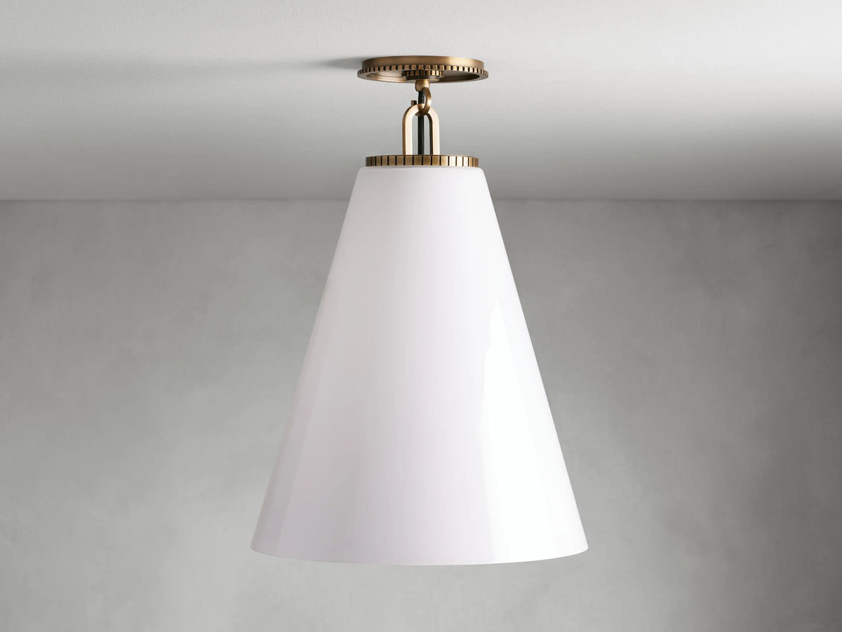 Cone-shaped flush mount light with milk glass shade and brass finish, mounted on ceiling. Matte background.
