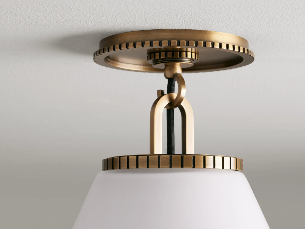 Wescott Cone Flush Mount with brass finish, featuring a large white milk glass cone shade, mounted on a ceiling.