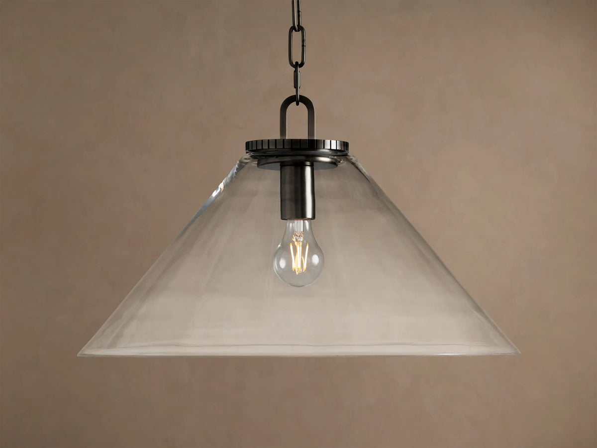 Wescott Cone Pendant: clear glass cone shade, dark bronze finish hardware, and exposed Edison bulb hanging against a tan wall.