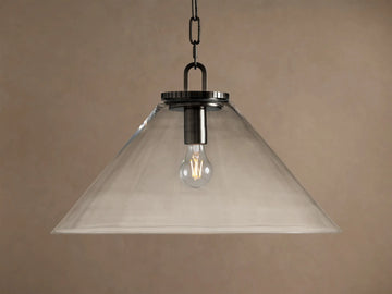 Wescott Cone Pendant: clear glass cone shade, dark bronze finish hardware, and exposed Edison bulb hanging against a tan wall.