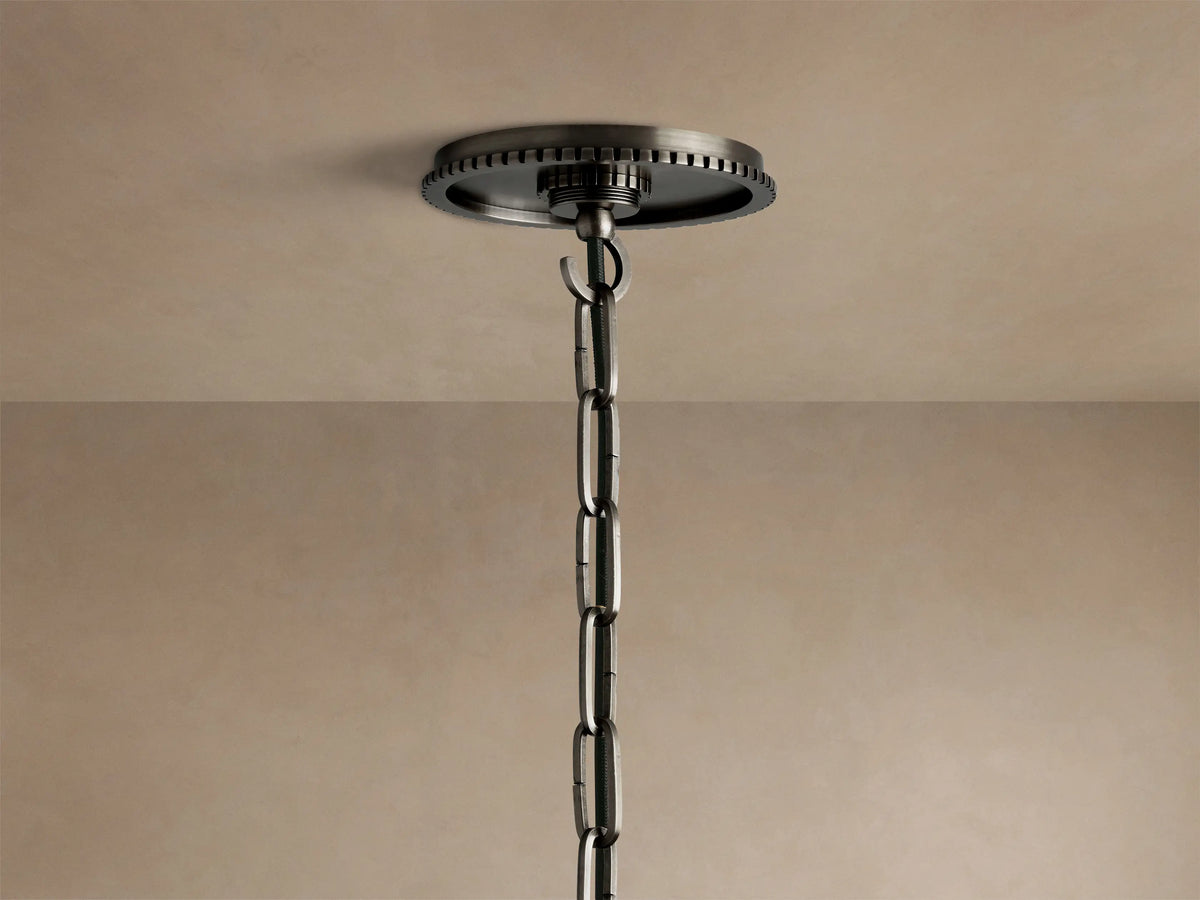 Close-up of the Wescott Cone Pendant's dark, brushed metal top, with a grooved ring connecting to the clear glass cone.