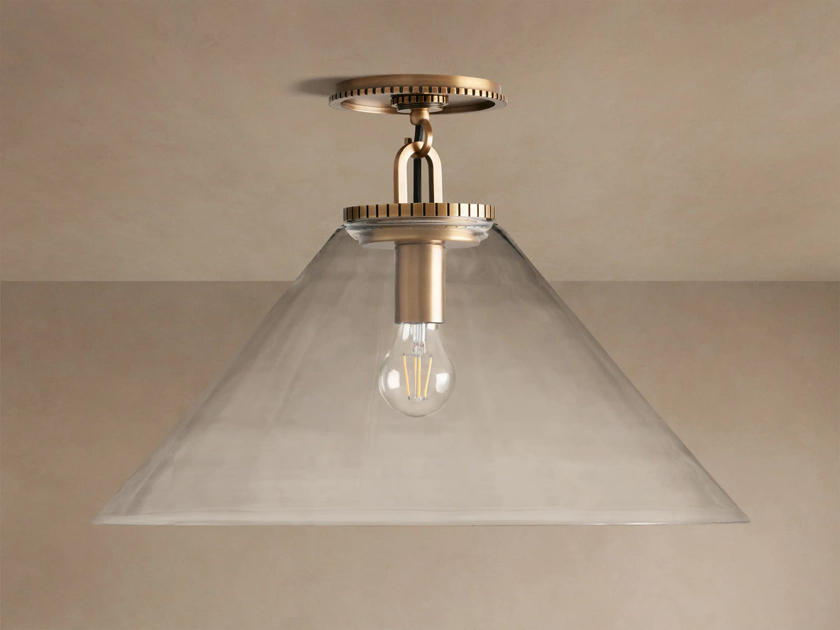Wescott Cone Flush Mount light with a brass finish, clear conical glass shade, and exposed filament bulb.