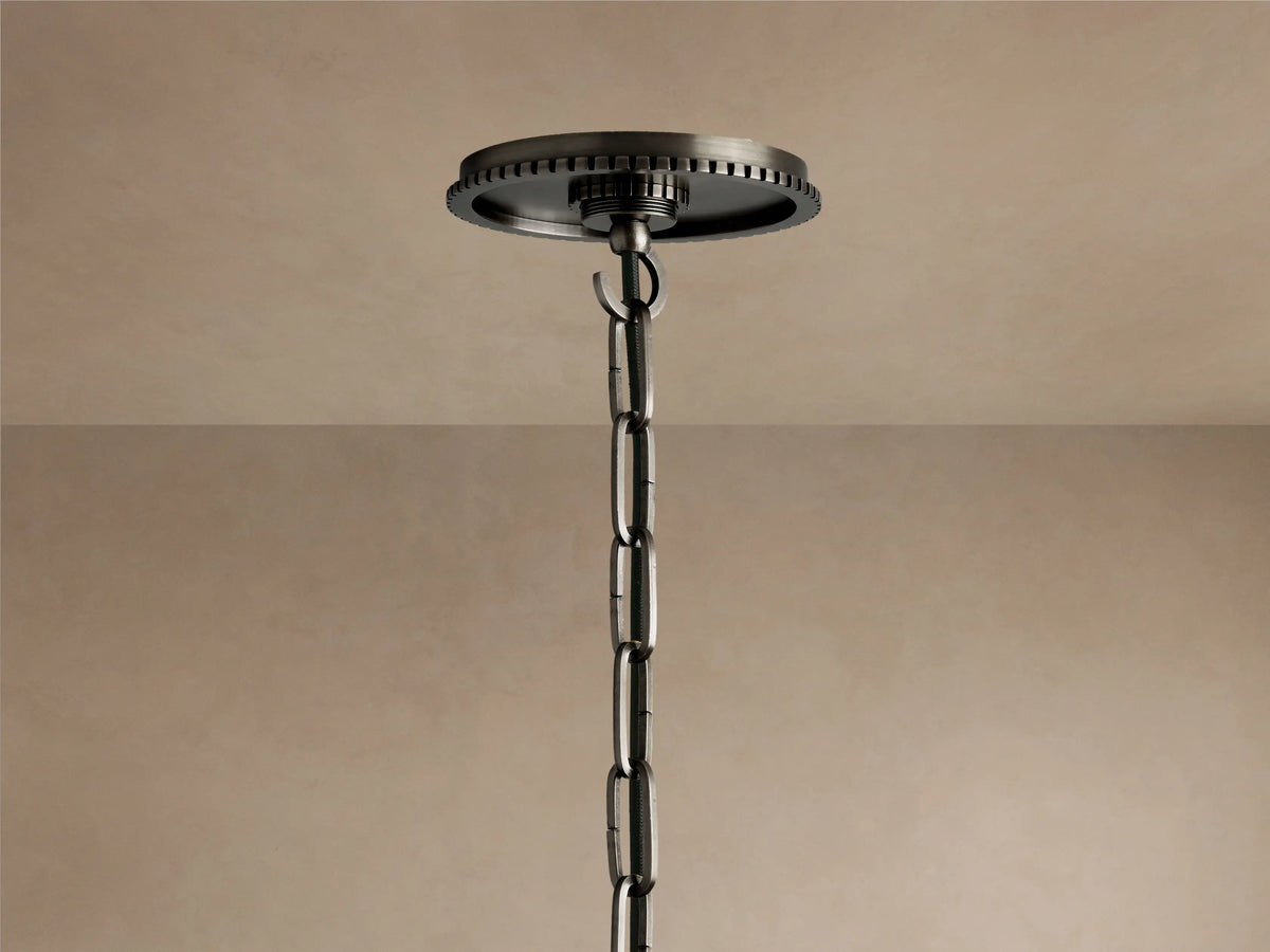 Close-up of Wescott Cone Pendant: dark bronze-finish metal fixture with vertical grooves meeting a milky white glass cone.