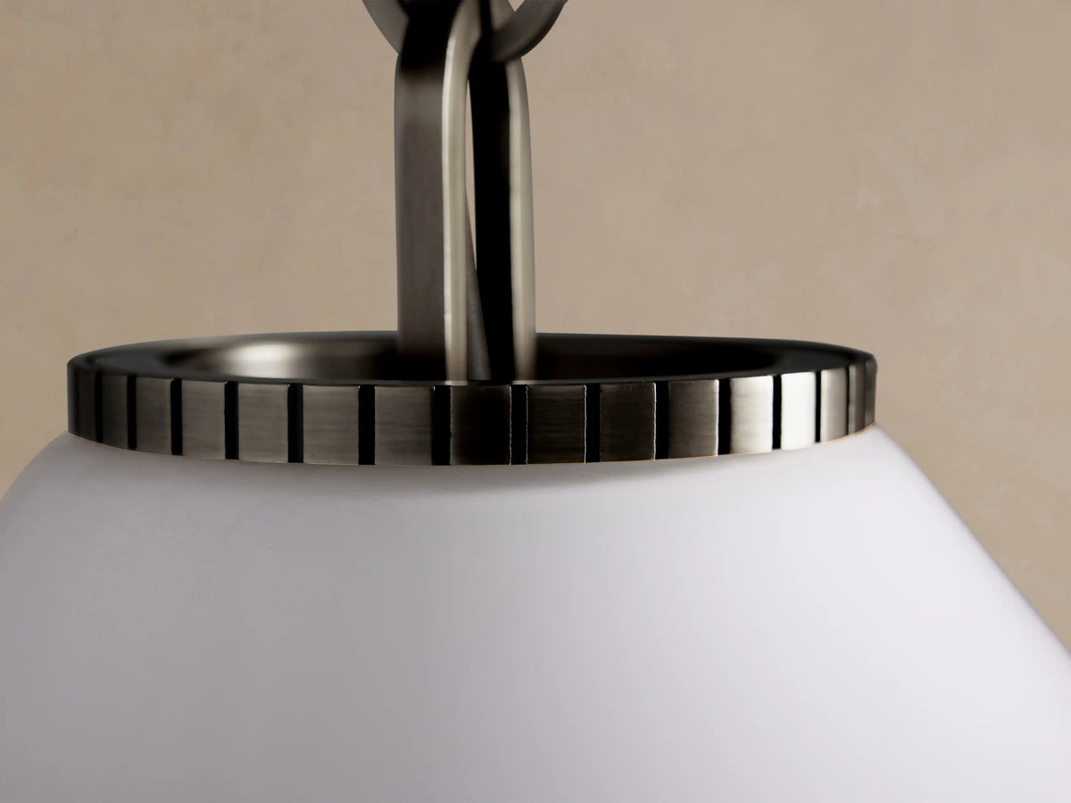Wescott Cone Pendant featuring a white milk glass cone shade and a dark bronze metallic rod, hung against a light beige wall.