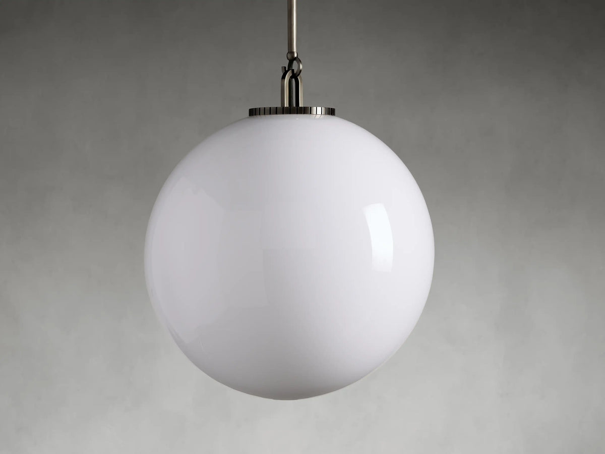 Wescott XL Globe Pendant with milk glass globe and steel fixture, suspended from a rod on a white background.