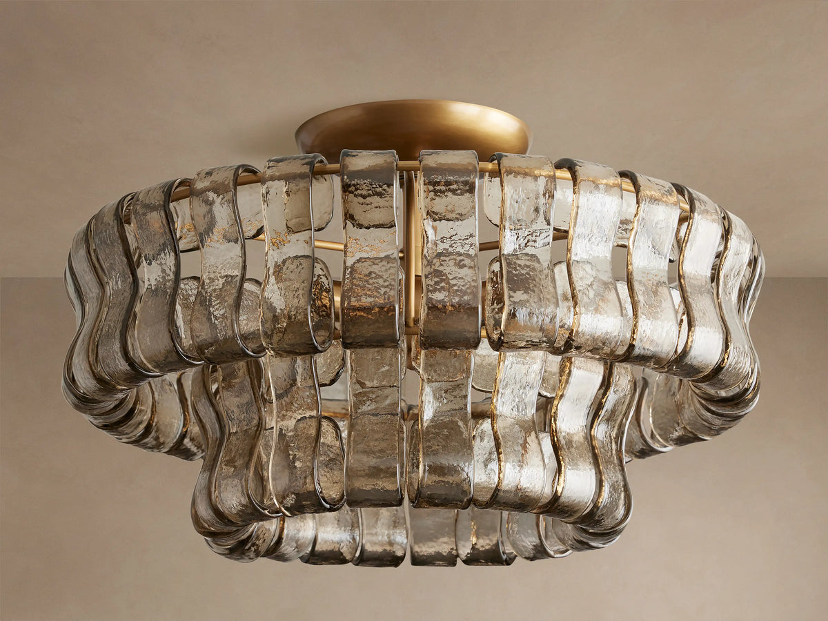 Ghiaccio Flush Mount: Textured, wavy, light amber glass bands in layered rows around a golden base, illuminating warmly.