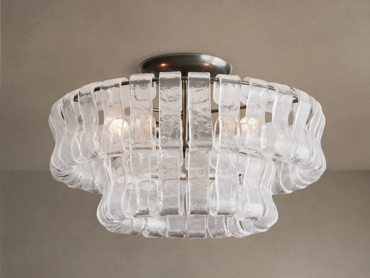 Ghiaccio Flush Mount with a dark steel base and layered, textured clear glass pieces forming a wavy, sculptural design. Soft glow.