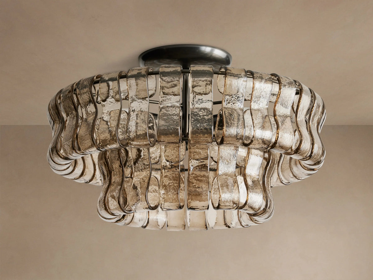 Ghiaccio Flush Mount with layered, curved, textured amber glass pieces and warm glowing lights, mounted on a ceiling.