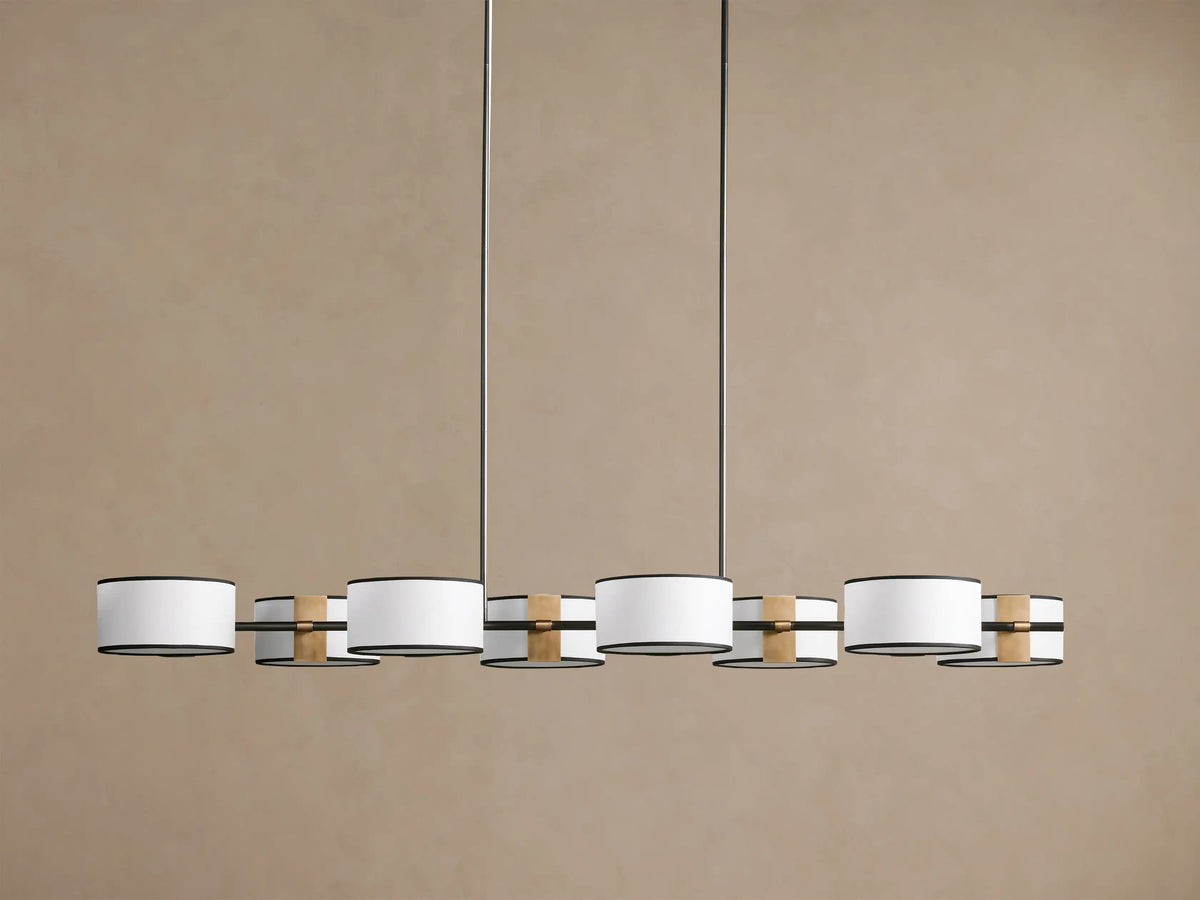 Daphne Fabric Linear Chandelier with 6 white fabric shades, black trim, and gold accents, hanging from two dark rods.