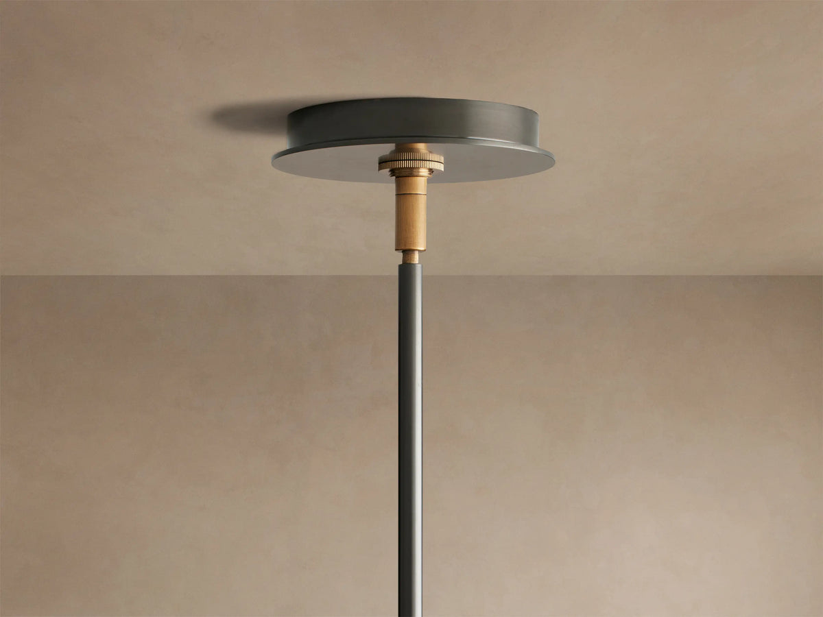 Close-up of Daphne Chandelier's white linen shade with black trim, attached to a black arm with a bronze accent.