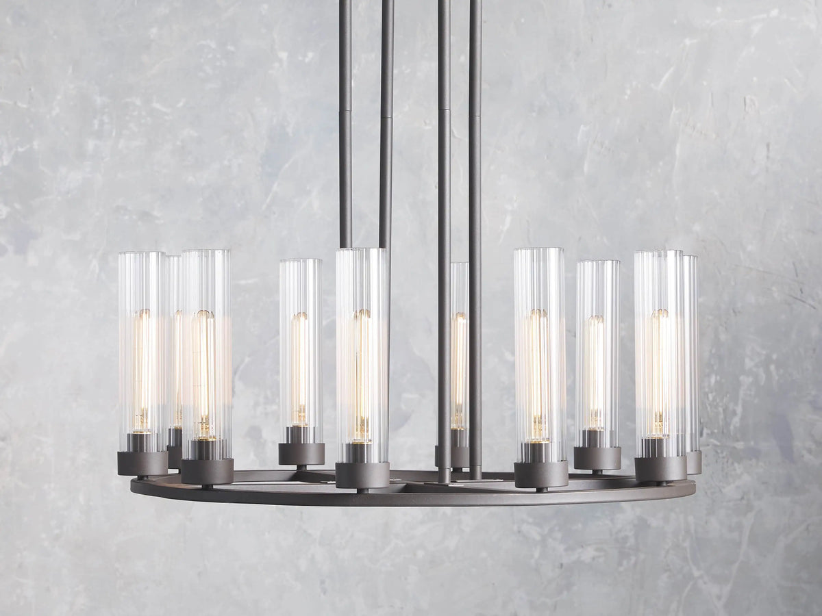 Andreas 10-Light Round Chandelier with bronze finish, featuring ten cylindrical glass shades, each holding a T9 bulb, on a round frame.