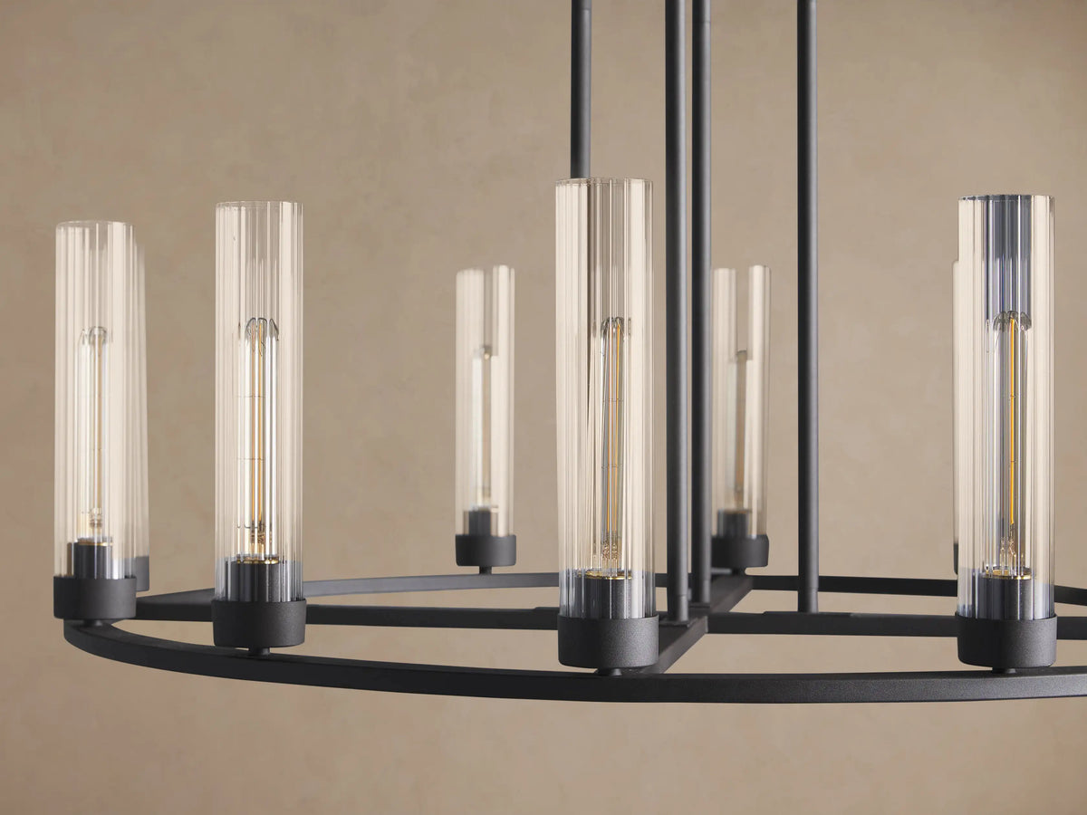 Andreas Round Chandelier, dark bronze finish. Circular frame holds multiple clear glass cylinder shades with visible filament bulbs.