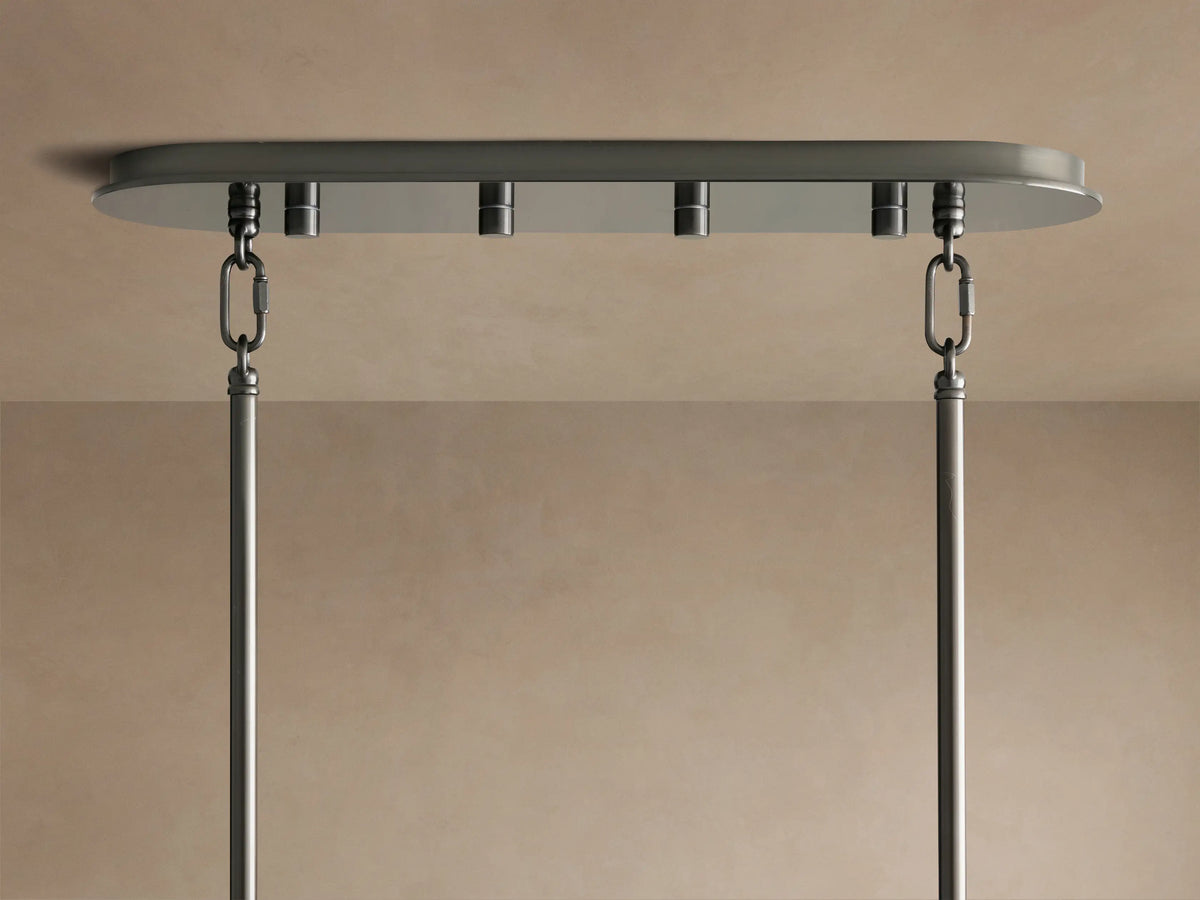 Delsie Oval Chandelier's bronze oval canopy mounted to a beige ceiling, with two chains and rods hanging down.