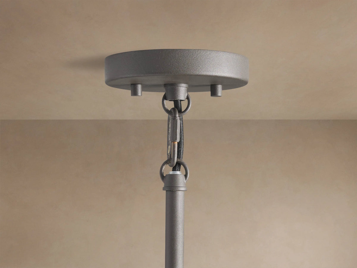 Andreas Pendant, a hanging fixture with a dark bronze finish, clear ribbed glass shade, and an exposed filament bulb.