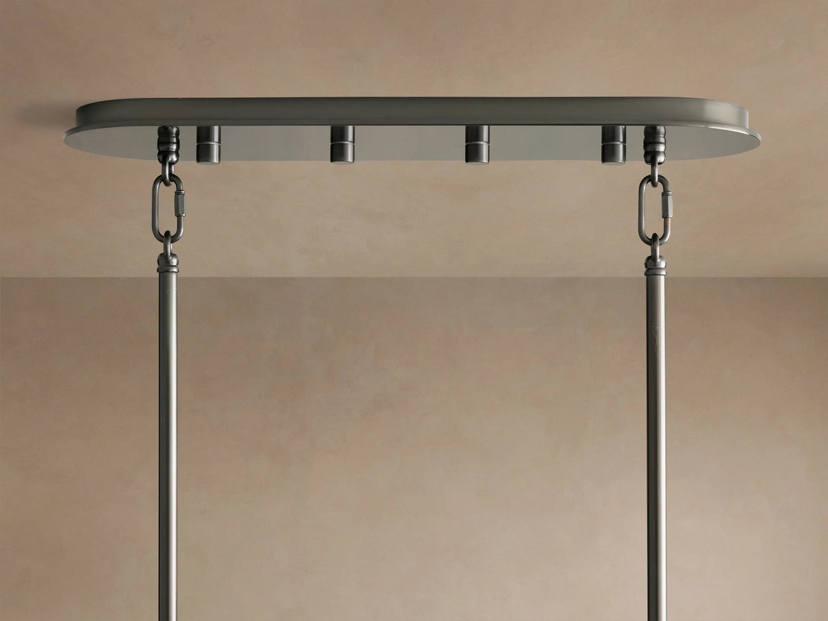 Delsie Oval Chandelier's dark bronze-toned oval canopy mounted to a light ceiling, with two metal chains and rods hanging.