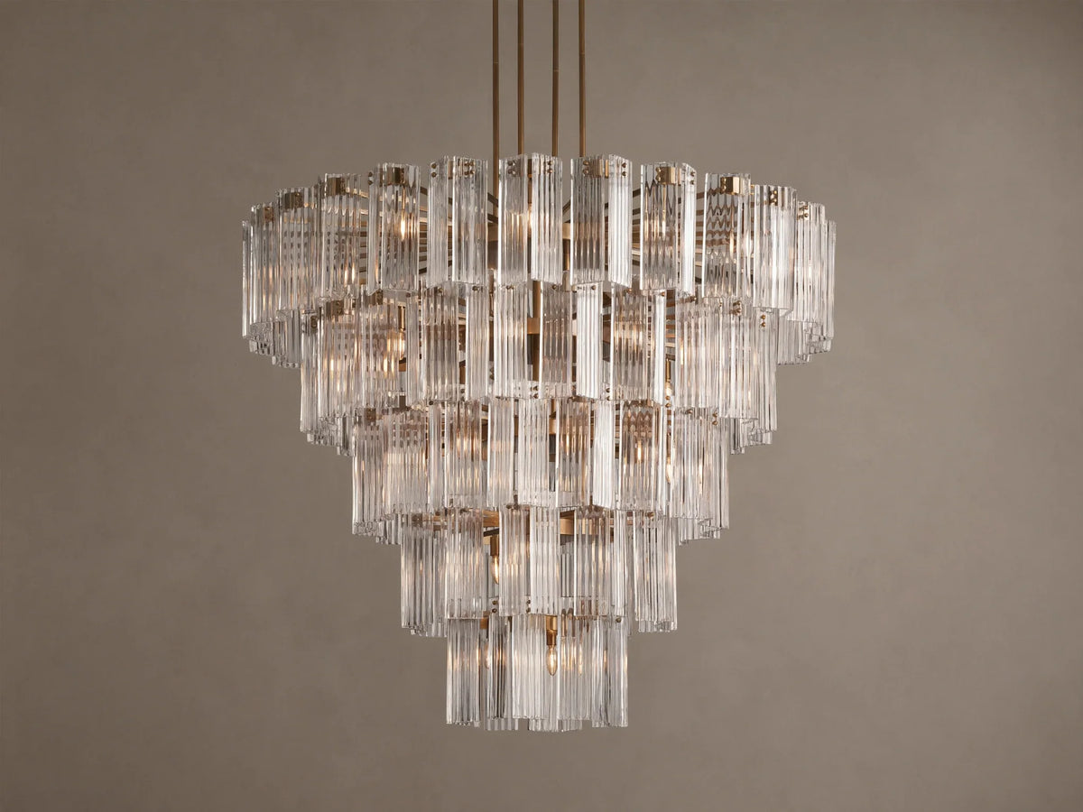 Delsie Round Chandelier: Tiered design with numerous clear vertical glass rods, burnished brass frame, brightly lit.